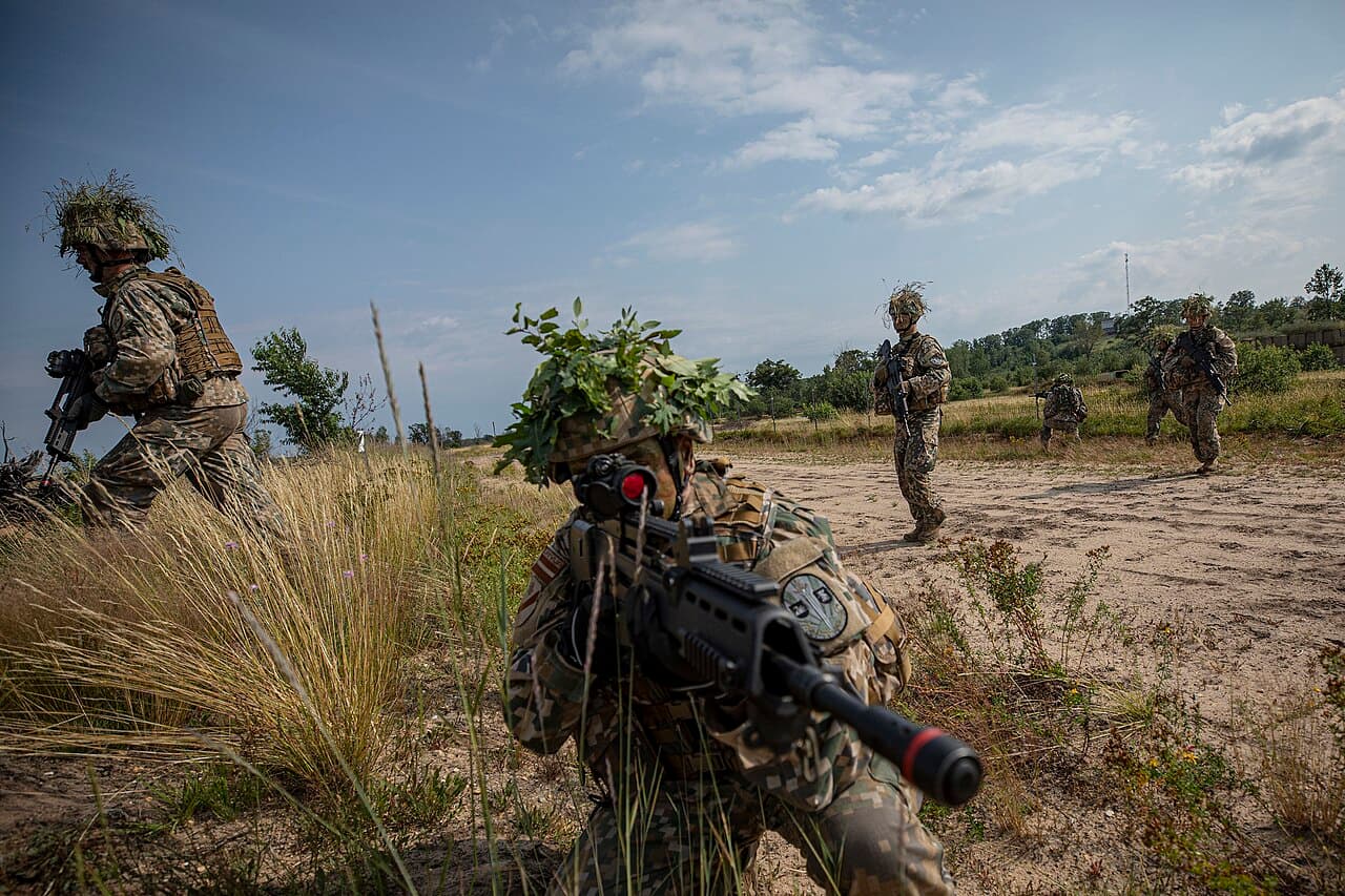 Armed escorts and stolen cameras mark a new step on Latvia's Belarus border