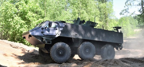 Patria 6x6 armoured vehicle driving across sandy terrain