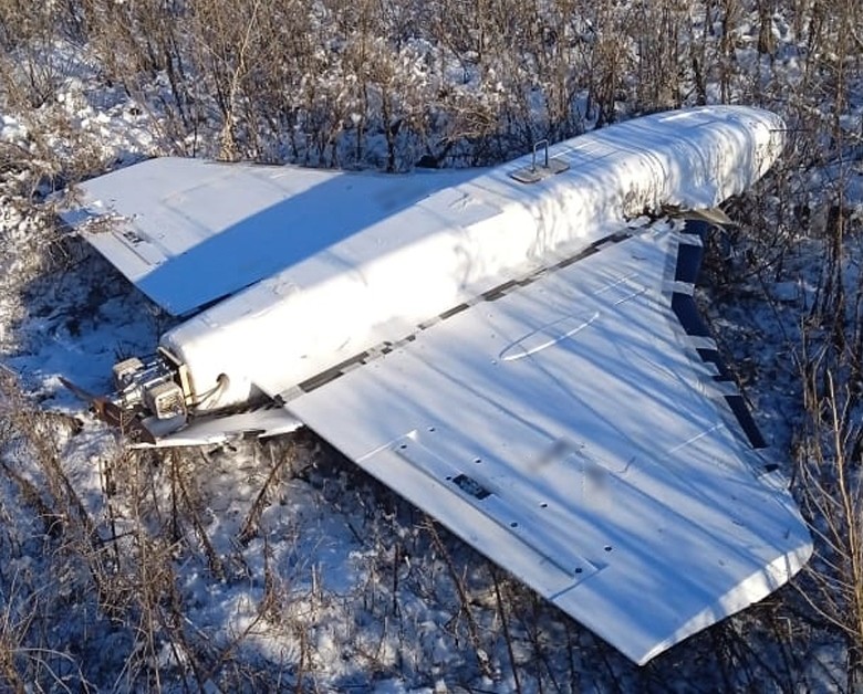 A Gerbera decoy drone airframe lying in snow-covered brush