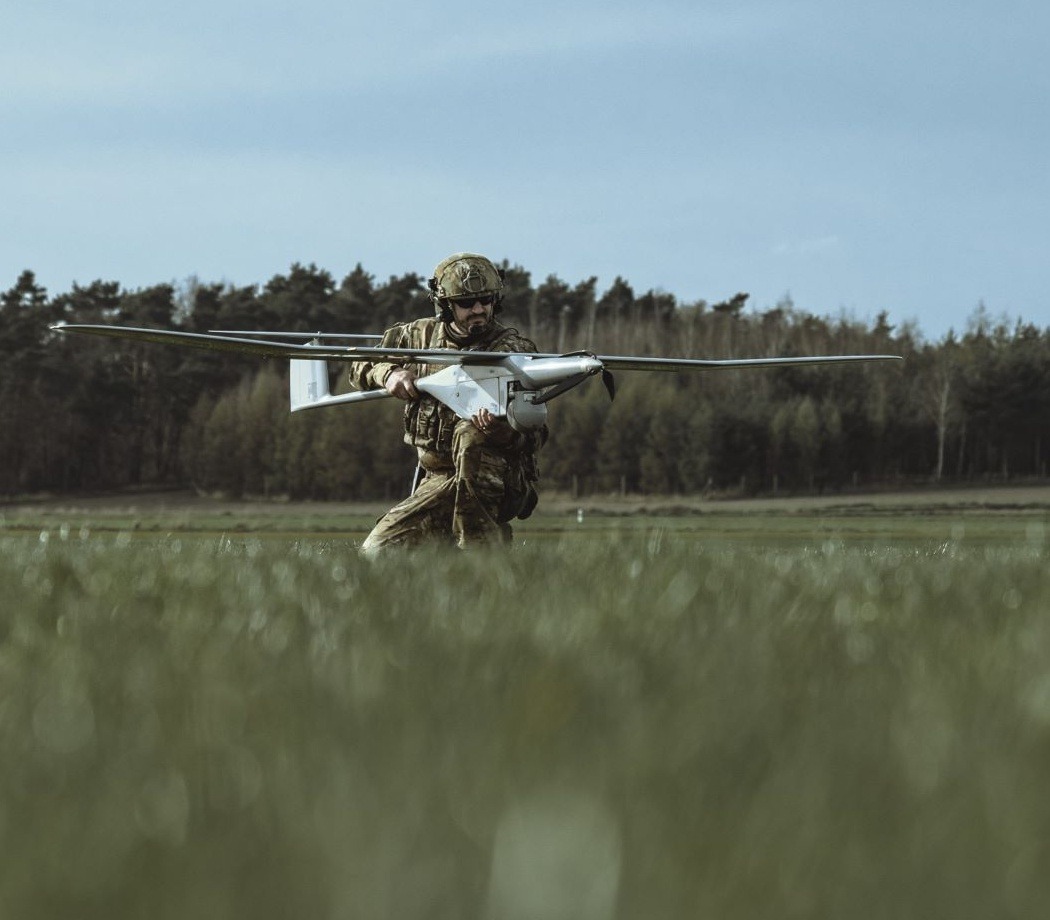 A soldier preparing to launch a WB Group FlyEye reconnaissance drone