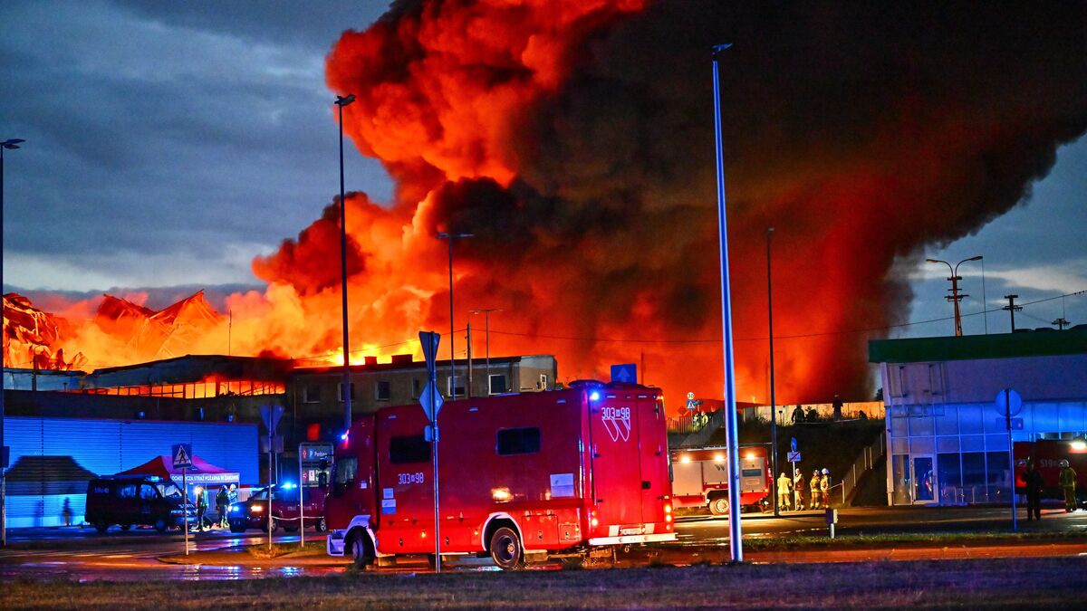 Firefighters and a heavy smoke plume at an industrial fire in Poland