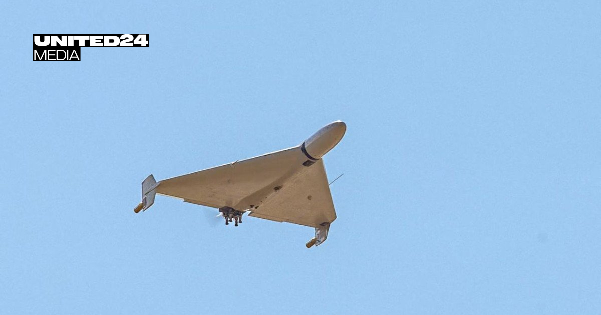 A Shahed-type drone in flight against a clear blue sky