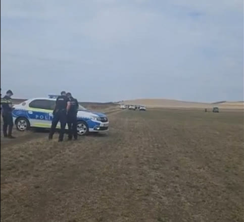 Romanian police at the field near Viișoara where the drone was found