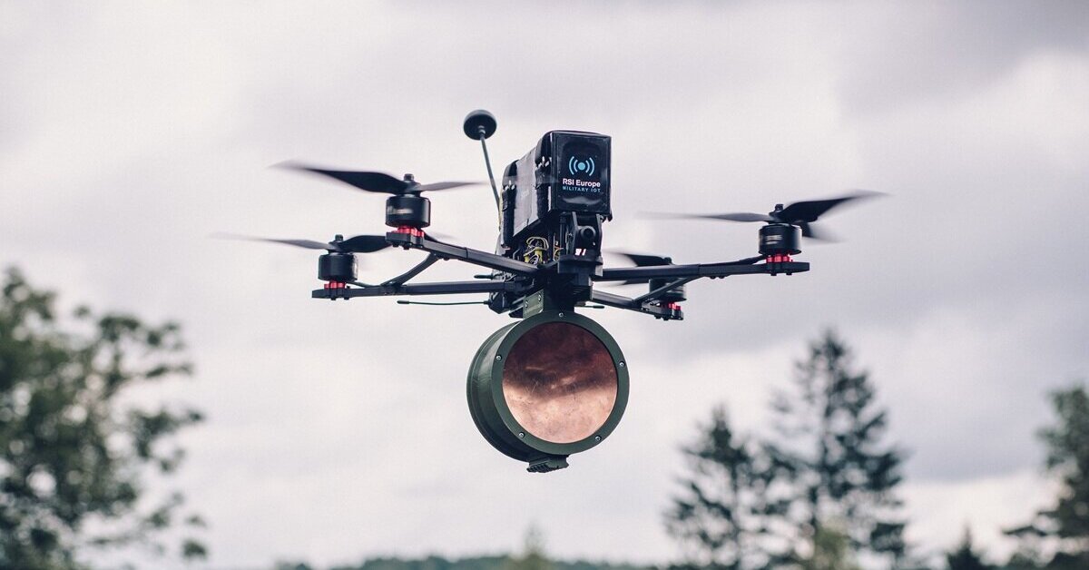 RSI Europe's Shpak FPV drone carrying a payload in flight, RSI Europe branding visible on the airframe