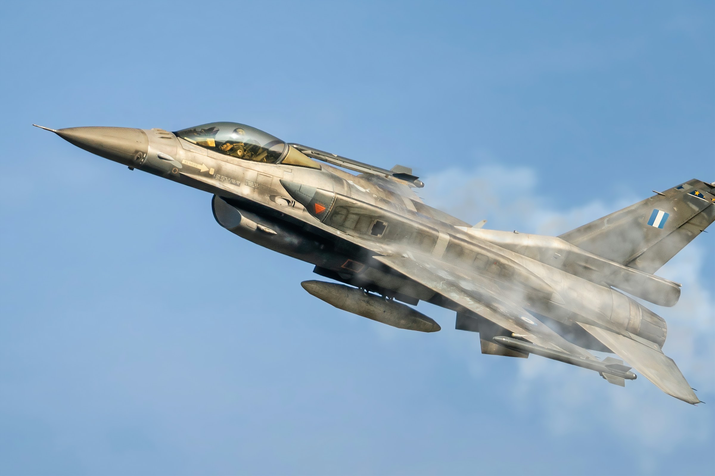 Hellenic Air Force F-16 fighter jet climbing against a blue sky